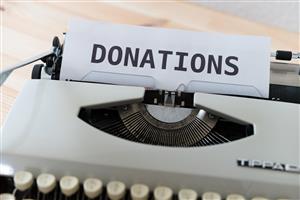 Donations typed on paper rolled into a typewriter